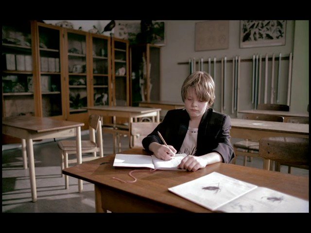 Video Reference: classroom, student, writing, notebook, desk, art room, empty room, child, tables, chairs, school, indoor, education, drawing