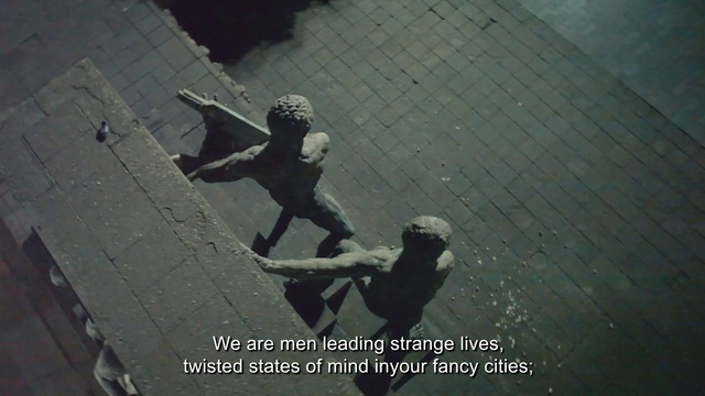 Video Reference: Flash photography, Asphalt, Art, Sculpture, Shadow, Pedestrian, Road surface, Darkness, Visual arts, Photo caption