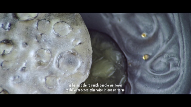 Video Reference: Light, Sleeve, Font, Electric blue, Science, Artifact, Metal, Rock, Macro photography, Darkness