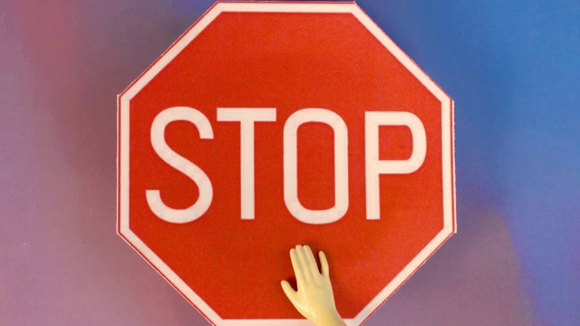 Video Reference: Gesture, Font, Traffic sign, Triangle, Material property, Stop sign, Street sign, Rectangle, Signage, Circle
