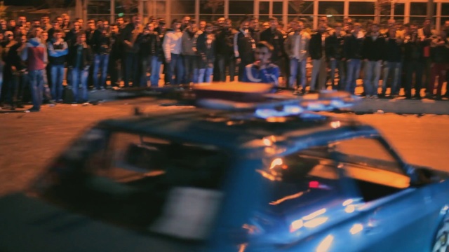 Video Reference: Entertainment, Fun, City, Event, Font, Performance art, Automotive design, Electric blue, Performing arts, Crowd