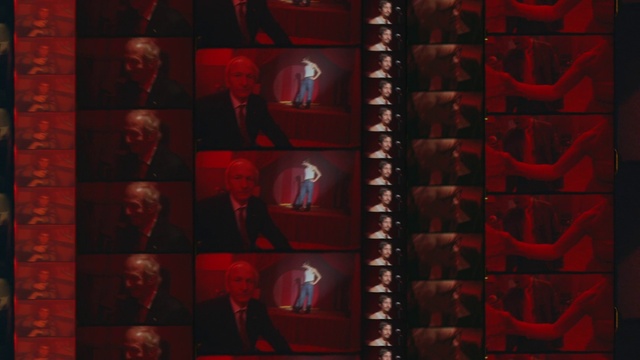Video Reference: Coat, Suit, Red, Blazer, Tie, Font, Art, Event, Room, Carmine