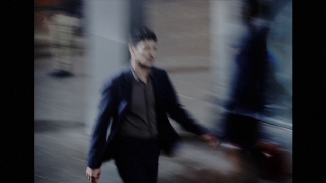 Video Reference: Flash photography, Gesture, Blazer, Tints and shades, Suit, Formal wear, Electric blue, White-collar worker, Event, Darkness