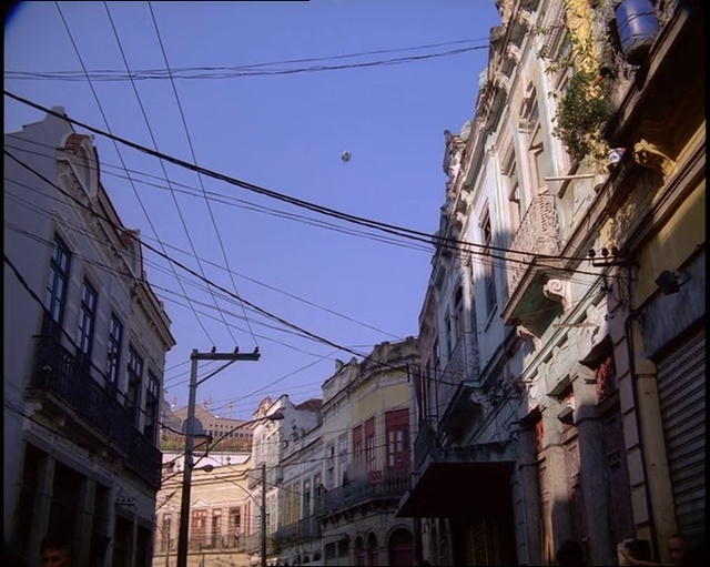 Video Reference: Building, Sky, Window, Blue, Electricity, Overhead power line, Neighbourhood, Line, House, Road surface