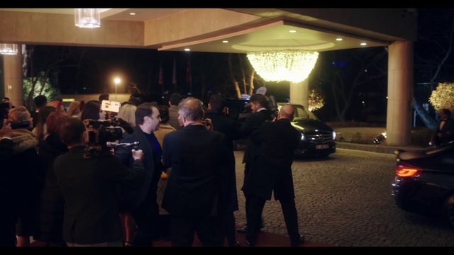 Video Reference: Tire, Car, Wheel, Coat, Automotive lighting, Vehicle, Suit, Formal wear, Personal luxury car, Event