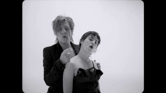 Video Reference: Clothing, Flash photography, Gesture, Black-and-white, Style, Interaction, Happy, Electronic device, Monochrome photography, Formal wear