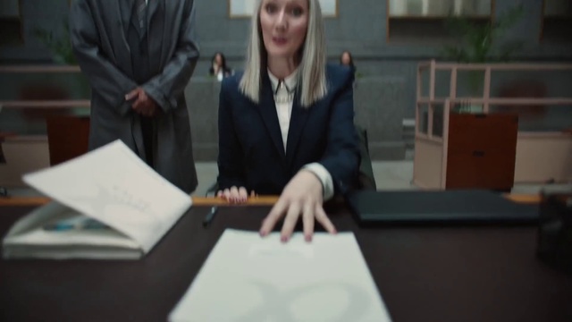 Video Reference: Table, Gesture, Blazer, White-collar worker, Font, Event, Desk, Formal wear, Job, Room