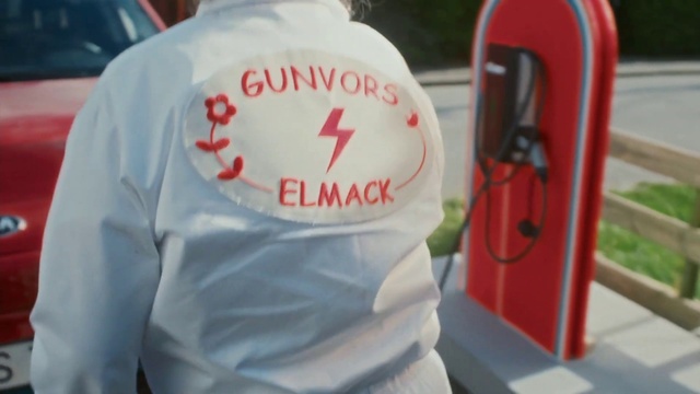 Video Reference: Sleeve, Motor vehicle, Gas, Automotive design, Font, Hat, T-shirt, Automotive exterior, Carmine, Vehicle door