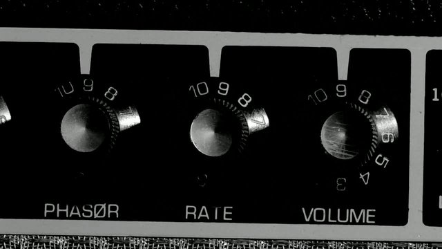 Video Reference: control panel, rotary knobs, dials, knobs, audio equipment, close-up, black panel, phase, rate, volume, analog, settings, hardware, interface