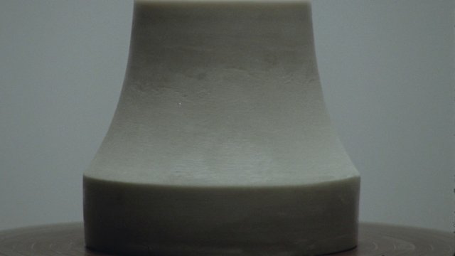 Video Reference: close-up, cylinder, abstract, minimal, gray background, object, surface, symmetry, still life, neutral, macro, simple, geometric, indoor, product shot