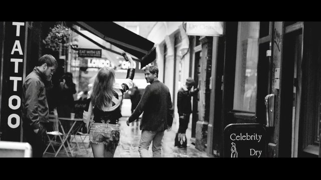 Video Reference: street, alley, pedestrian, people, city, storefront, black and white, urban, walking, outdoors, narrow street, candid, travel, shop signs