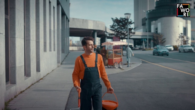 Video Reference: Building, Infrastructure, Road surface, Tire, Workwear, Orange, Asphalt, Mode of transport, Vest, Road