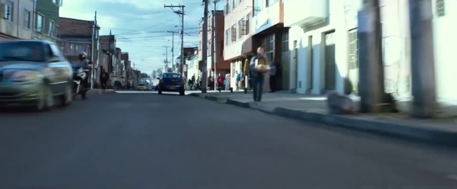 Video Reference: Building, Road surface, Vehicle, Asphalt, Cloud, Car, Sky, Tire, Sidewalk, Urban design
