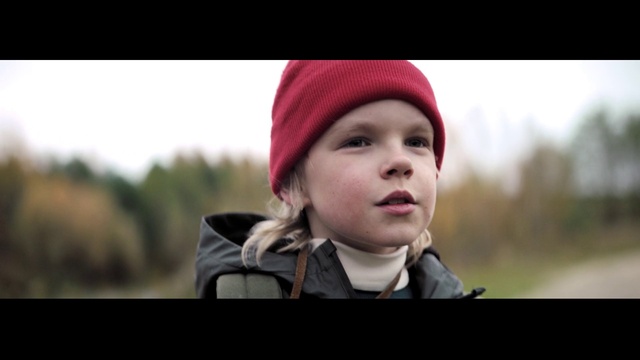 Video Reference: Cheek, Outerwear, Facial expression, Flash photography, Cap, Headgear, Street fashion, Happy, Toddler, Grass