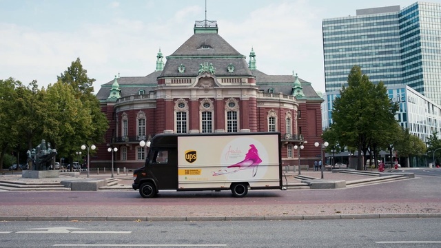 Video Reference: Sky, Building, Tree, Vehicle, Cloud, Mode of transport, Thoroughfare, Road surface, Asphalt, Wheel