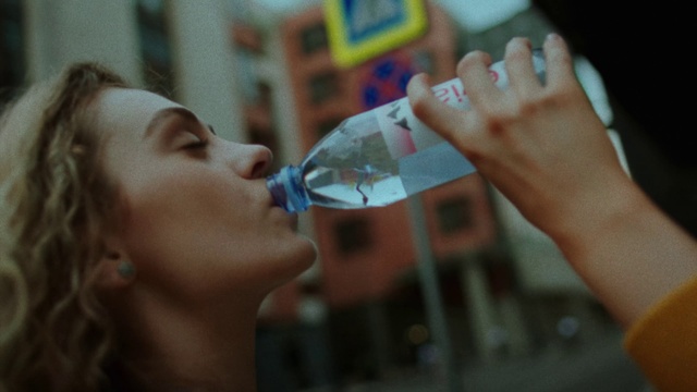 Video Reference: Skin, Drinkware, Eyelash, Bottle, Liquid, Fluid, Water bottle, Gesture, Plastic bottle, Alcoholic beverage