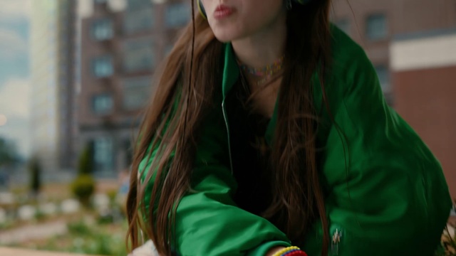 Video Reference: Hair, Lip, Green, Neck, Eyewear, Black hair, Blazer, Layered hair, Grass, Happy