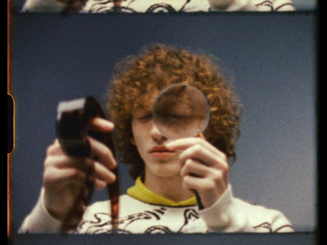 Video Reference: Hairstyle, Eyebrow, Jheri curl, Jaw, Neck, Art, Eyelash, Gesture, Eyewear, Electronic device