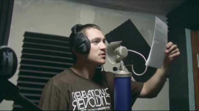 Video Reference: Hairstyle, Microphone, Ear, Flash photography, Audio equipment, Hearing, Gadget, Cool, T-shirt, Electronic device