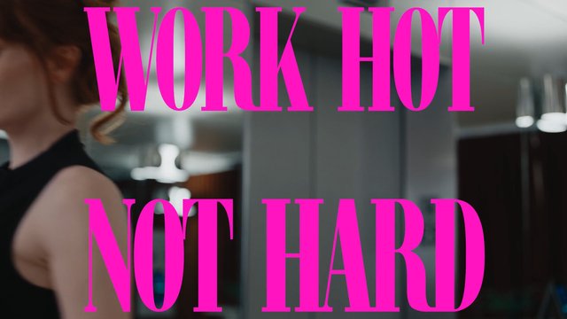 Video Reference: indoor, person, text overlay, pink text, motivational quote, blurred background, close-up, office, interior, fitness, workout, fashion, modern