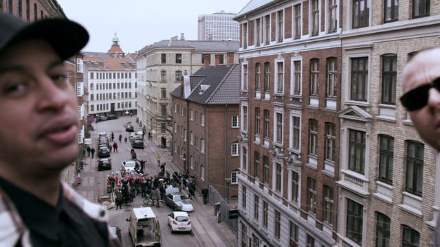 Video Reference: Building, Window, Daytime, Car, Sky, Vehicle, Infrastructure, Architecture, Hat, Neighbourhood