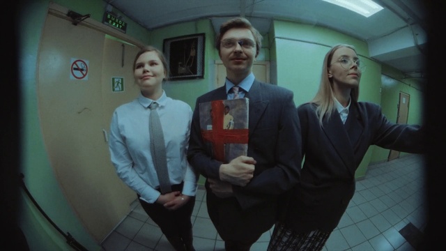 Video Reference: Tie, Gesture, Flash photography, Collar, Dress shirt, Smile, Air travel, Blazer, White-collar worker, Formal wear