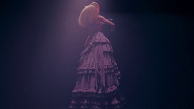 Video Reference: Clothing, Microphone, Dress, Human body, Purple, Flash photography, Plant, Performing arts, Violet, Concert