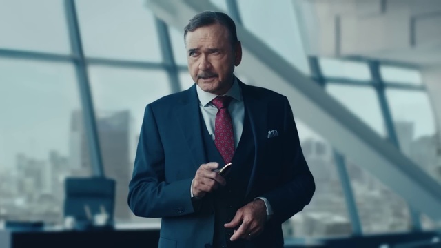 Video Reference: Microphone, Tie, Dress shirt, Gesture, Suit, Blazer, Building, White-collar worker, Audio equipment, Spokesperson