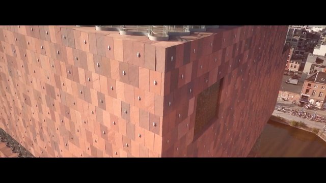 Video Reference: aerial, building, architecture, facade, modern, brick, urban, cityscape, canal, exterior, rooftop, pattern, construction, waterfront