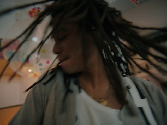 Video Reference: Forehead, Hairstyle, Cool, Eyelash, Black hair, Dreadlocks, Long hair, Eyewear, Event, Audio equipment