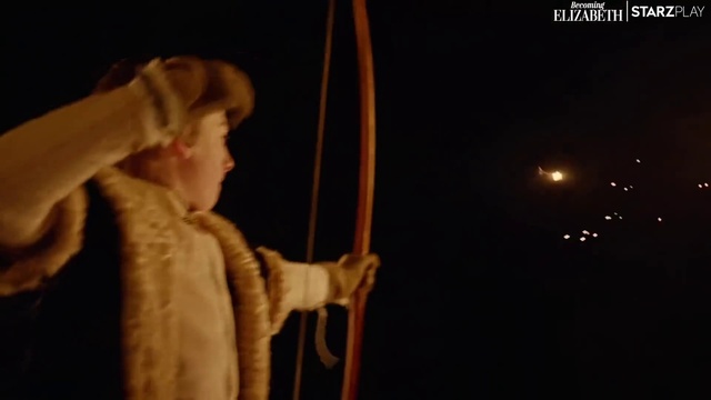 Video Reference: Bow, Event, Darkness, Entertainment, Longbow, Performing arts, Arrow, Rope, Hat, Performance art