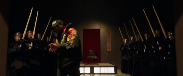 Video Reference: Fedora, Sun hat, Hat, Performing arts, Entertainment, Music, Event, Curtain, Flag, Darkness