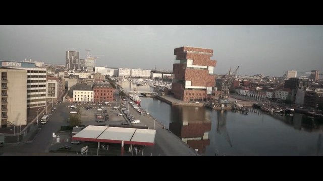 Video Reference: cityscape, waterfront, canal, harbor, buildings, urban, dock, boats, parking lot, bridge, reflection, skyline, architecture, industrial, daytime
