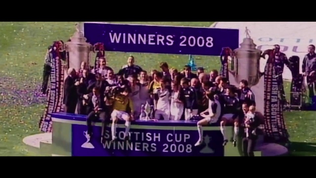 Video Reference: Purple, Dress, Font, Entertainment, Electronic device, Stage equipment, Crowd, Event, Magenta, Display device