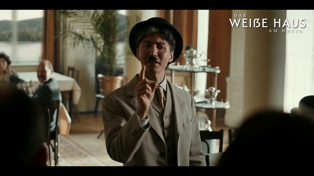 Video Reference: Hat, Sun hat, Flash photography, Gesture, Happy, Fedora, Formal wear, Event, White-collar worker, Tie