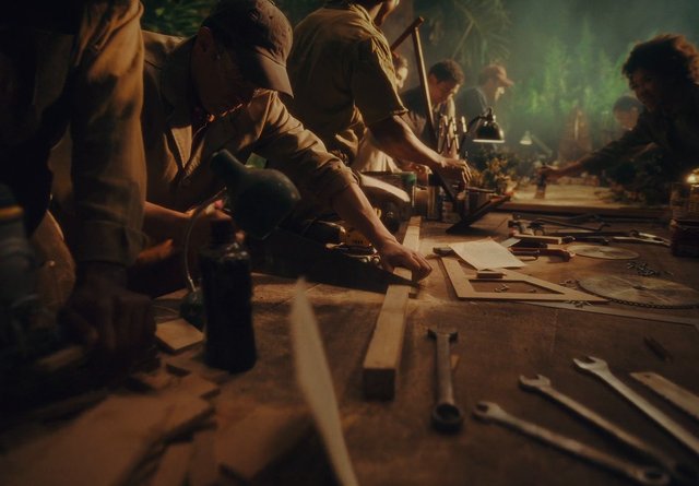 Video Reference: workshop, tools, people, table, hands, crafting, repair, workbench, indoor, group, dimly lit, manual work, equipment, organization, project, industry