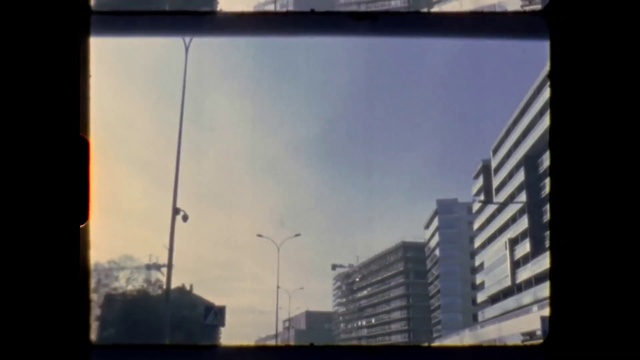 Video Reference: Sky, Building, Cloud, Automotive mirror, Rectangle, Tints and shades, City, Tower block, Rear-view mirror, Glass