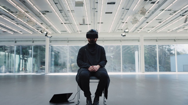 Video Reference: Standing, Hat, Building, White-collar worker, Fashion design, Eyewear, Formal wear, Event, Boot, Sitting