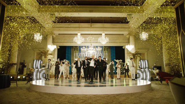 Video Reference: Decoration, Dress, Lighting, Chair, Hall, Suit, Formal wear, Chandelier, Event, Ceiling