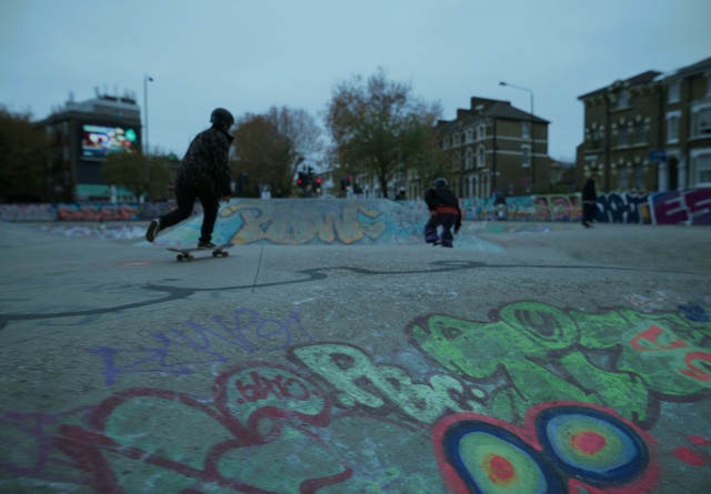 Video Reference: Sky, Daytime, Tree, Road surface, Asphalt, Sports equipment, Art, Public space, Paint, People