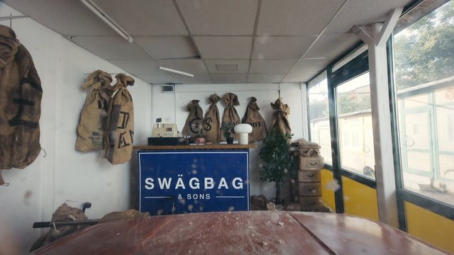 Video Reference: interior, shop, warehouse, burlap sacks, counter, sign, windows, indoor, retail, storage, rustic, office, bags, plants