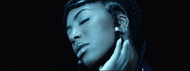 Video Reference: Lip, Chin, Eyebrow, Eye, Eyelash, Flash photography, Microphone, Lighting, Music artist, Earrings