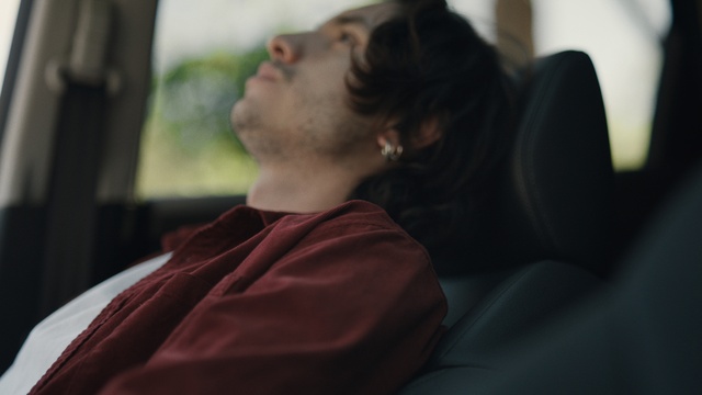 Video Reference: Shoulder, Comfort, Neck, Happy, Eyewear, Sitting, Audio equipment, Facial hair, Room, White-collar worker