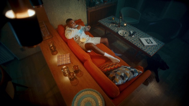 Video Reference: Coffin, Couch, Orange, Living room, Comfort, Table, House, Wood, Flooring, Linens