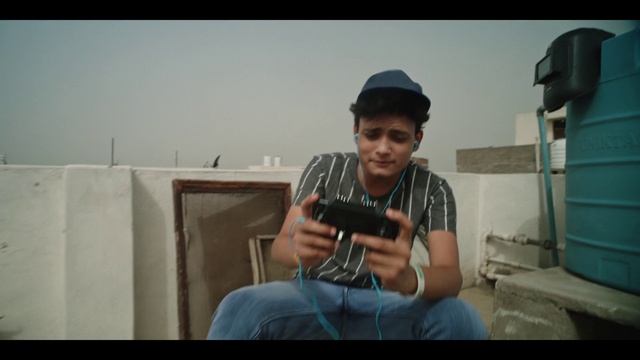 Video Reference: Flash photography, Photographer, Cap, T-shirt, Baseball cap, Camera lens, Hat, Cameras & optics, Camera, Travel