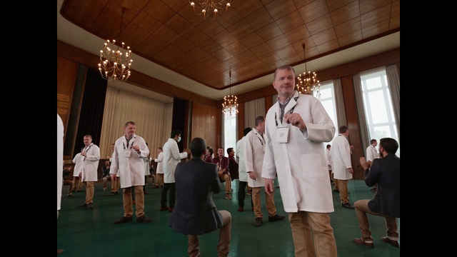 Video Reference: Footwear, Trousers, Tie, Window, Dress, Chair, Formal wear, Curtain, Performing arts, Event