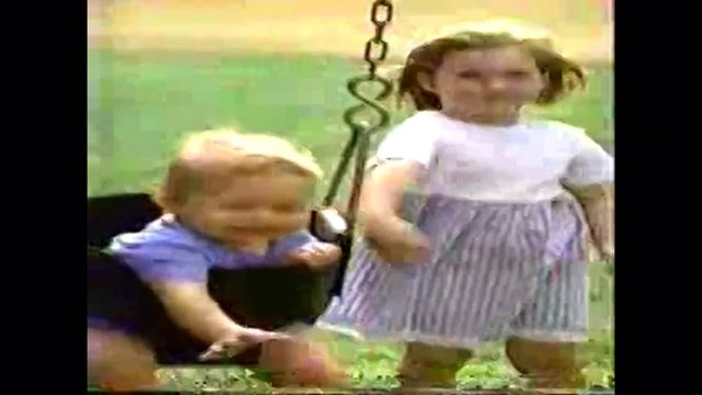 Video Reference: children, kids, playground, swing, outdoors, playing, childhood, blurry, low_resolution, grass, daytime, backyard