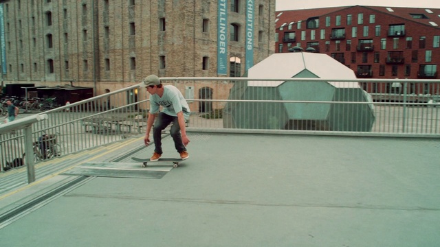 Video Reference: Building, Sports equipment, Window, Kickflip, Skateboard truck, Skateboarder, Asphalt, Skateboard, Skatepark, Fence