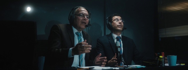 Video Reference: Glasses, Microphone, Hand, Coat, Tie, Organism, Gesture, Spokesperson, Suit, Blazer