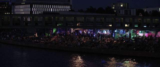 Video Reference: Water, Purple, Entertainment, Crowd, City, Waterway, Midnight, Building, Event, Performing arts